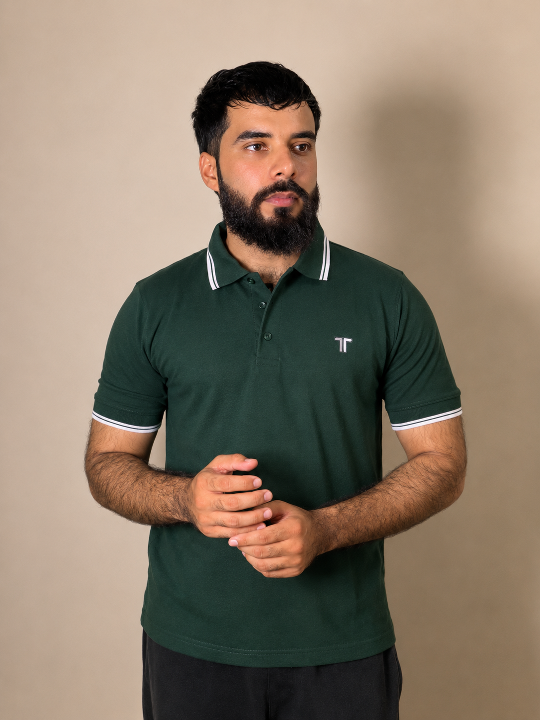 Men’s Forest green polo shirt with white trim and embroidered logo, modeled for a stylish casual wear collection